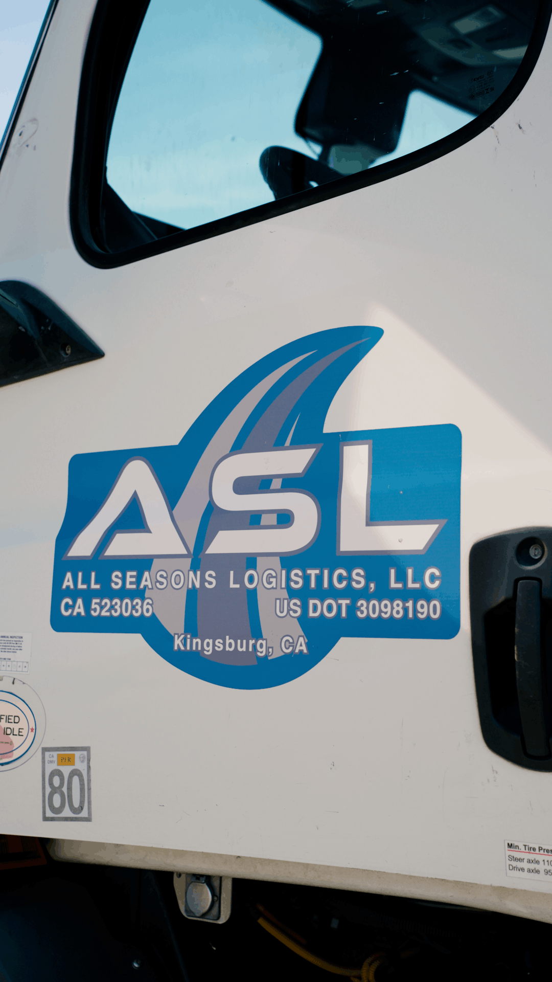 All Seasons Logistics logo on a white truck cab